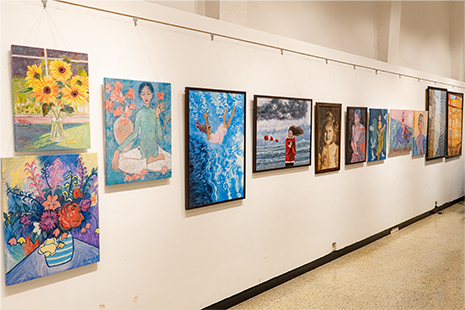 Gallery wall filled with colorful contemporary paintings